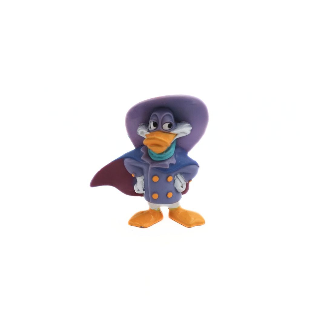 Front on photo of a 90's Darkwing Duck figure with hands on his hips, wearing cape and hat