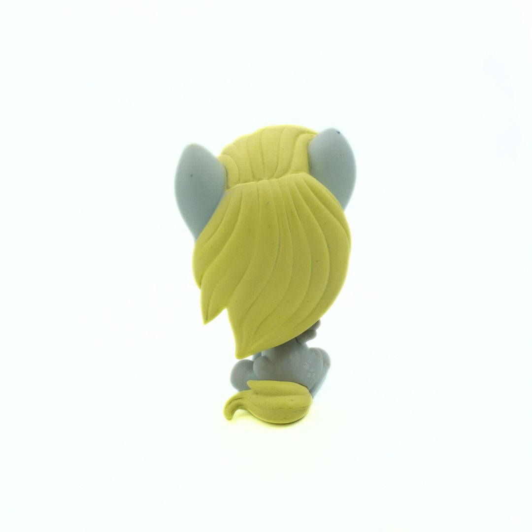 Toy figure with yellow hair and gray horns on a white background