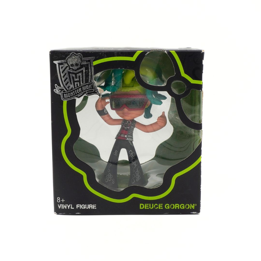 Vinyl figure in packaging with 'Monster High' branding on a white background