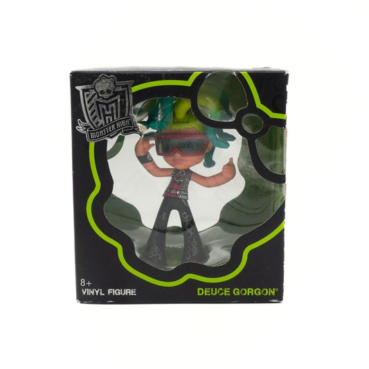 Vinyl figure in packaging with 'Monster High' branding on a white background
