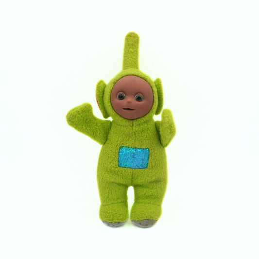 Green plush toy with a blue pocket on a white background