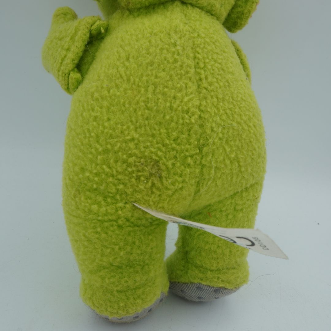Teletubby green plush toy with marks to its behind