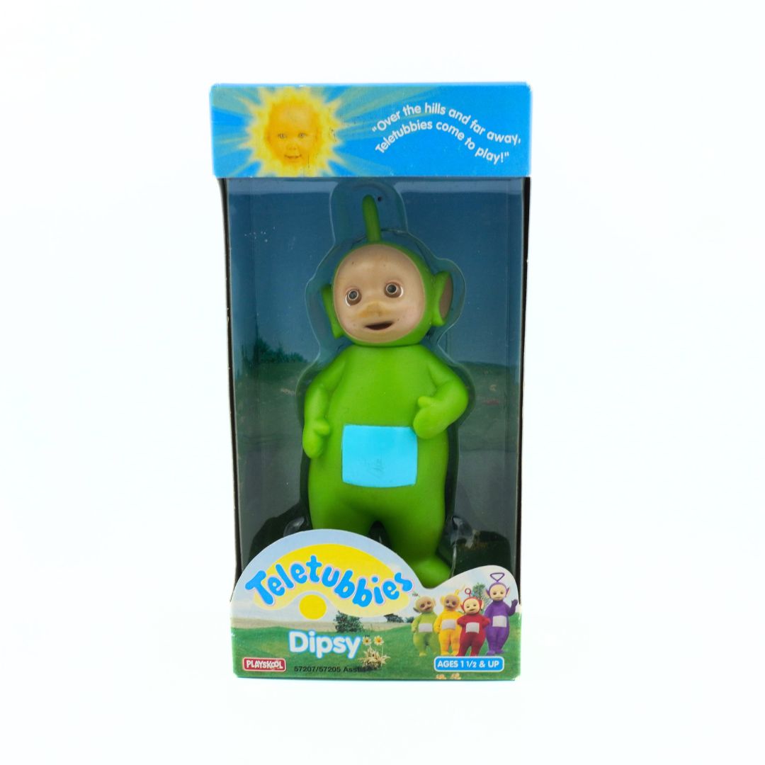 Green Teletubby toy figure in packaging with 'Teletubbies' branding.