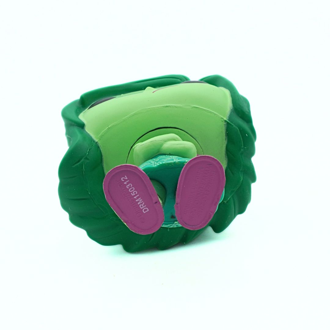 Green and purple toy resembling a cabbage on a white background