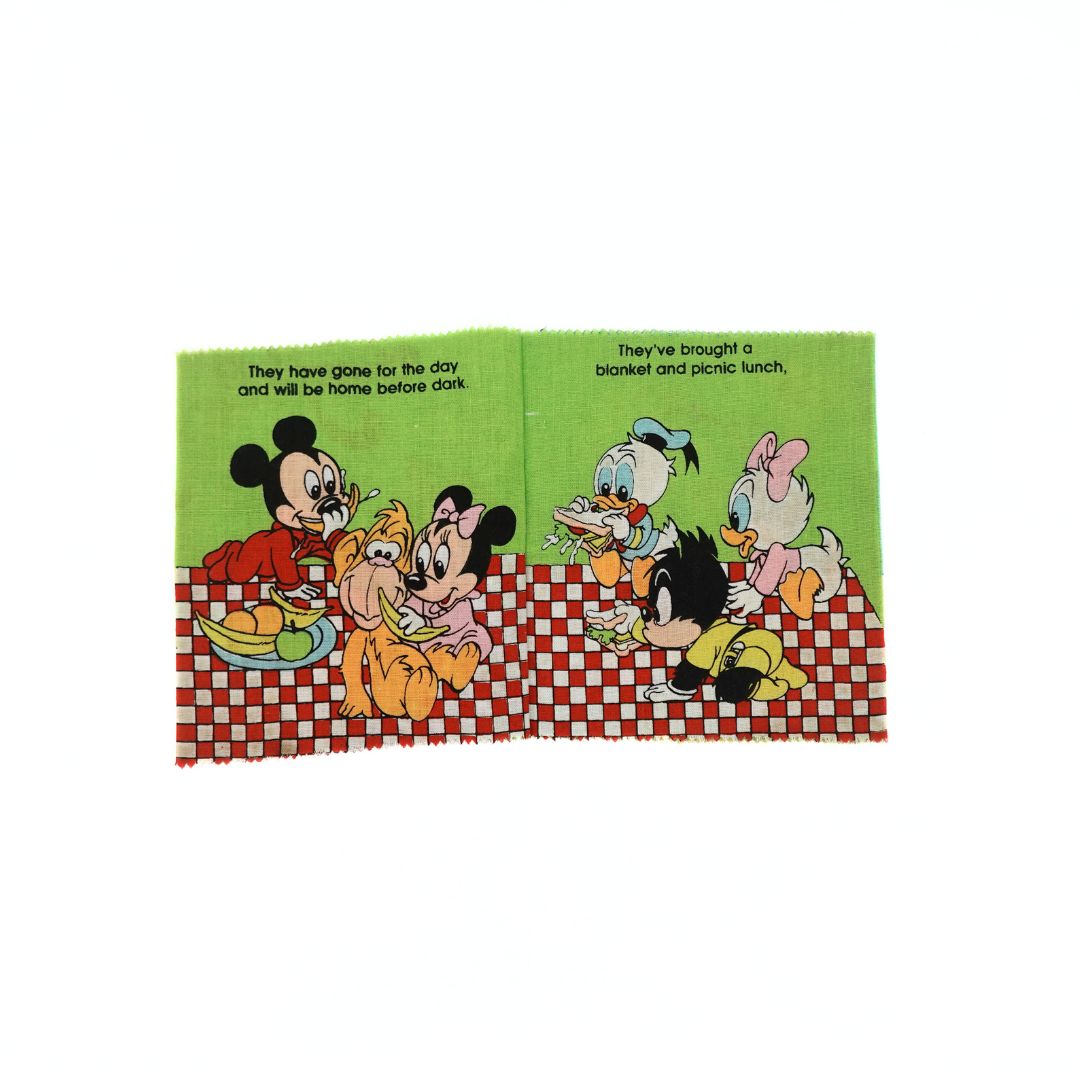 Internal pages of Disney baby characters eating at a picnic from the 1986 Picnic fabric book