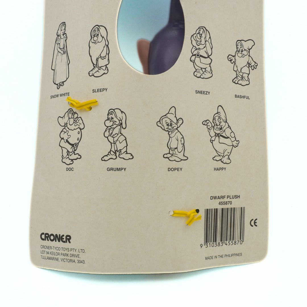 Back of a plush toy packaging with illustrations of dwarfs and branding details.