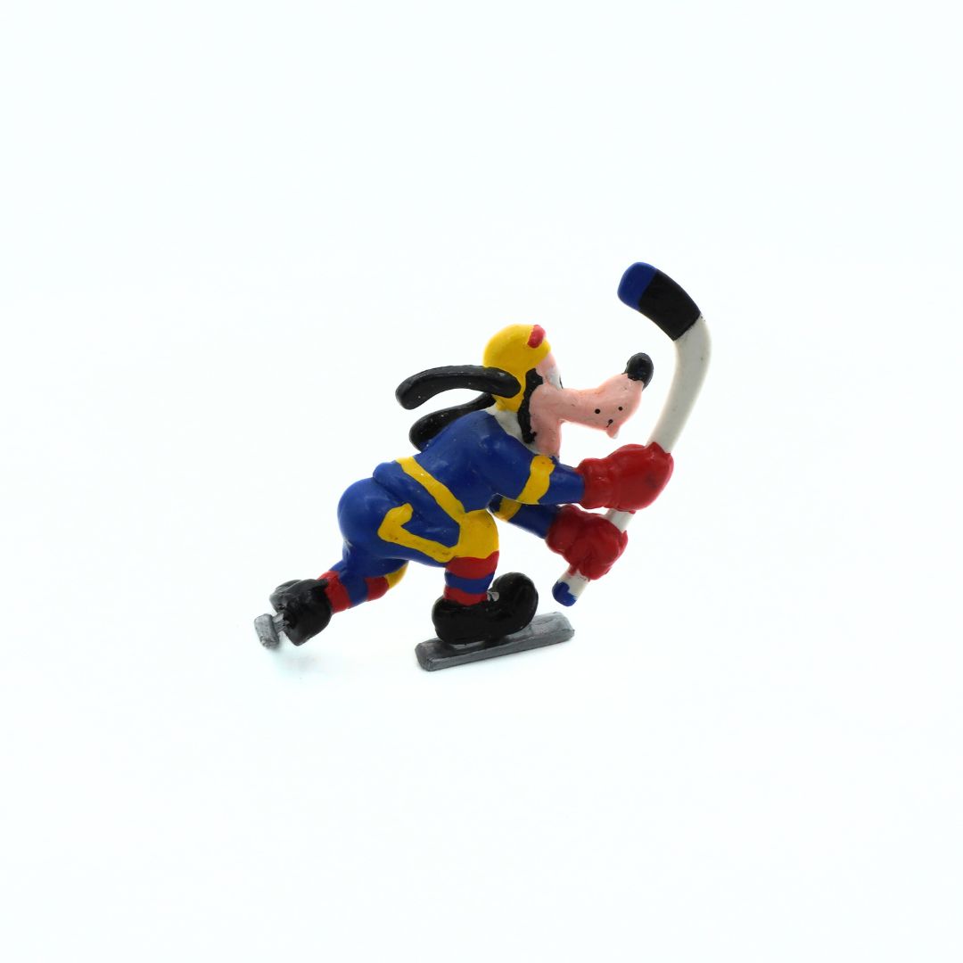 Colorful toy figure of a character playing hockey on a white background