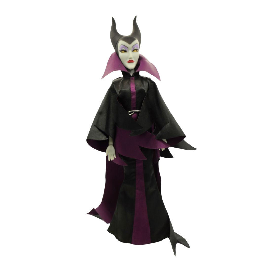 A Maleficent from Sleeping Beauty figurine with a black and purple dress, black hat and green face.