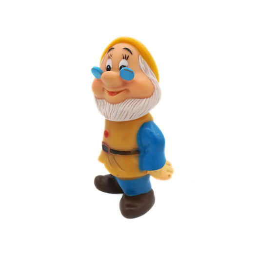 Toy figure of a dwarf with a yellow hat and blue shoes on a white background