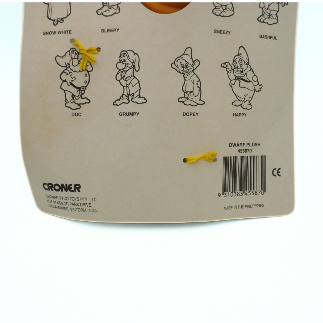 Back of a plush toy packaging with cartoon dwarves and branding details.