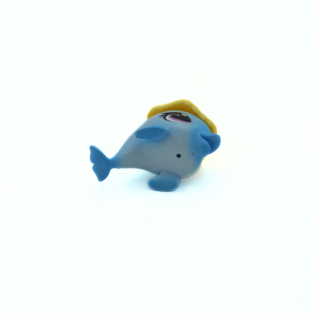 Blue dolphin figurine with a yellow hat on a white background