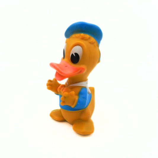 Toy duck figure with a blue cap and outfit on a white background