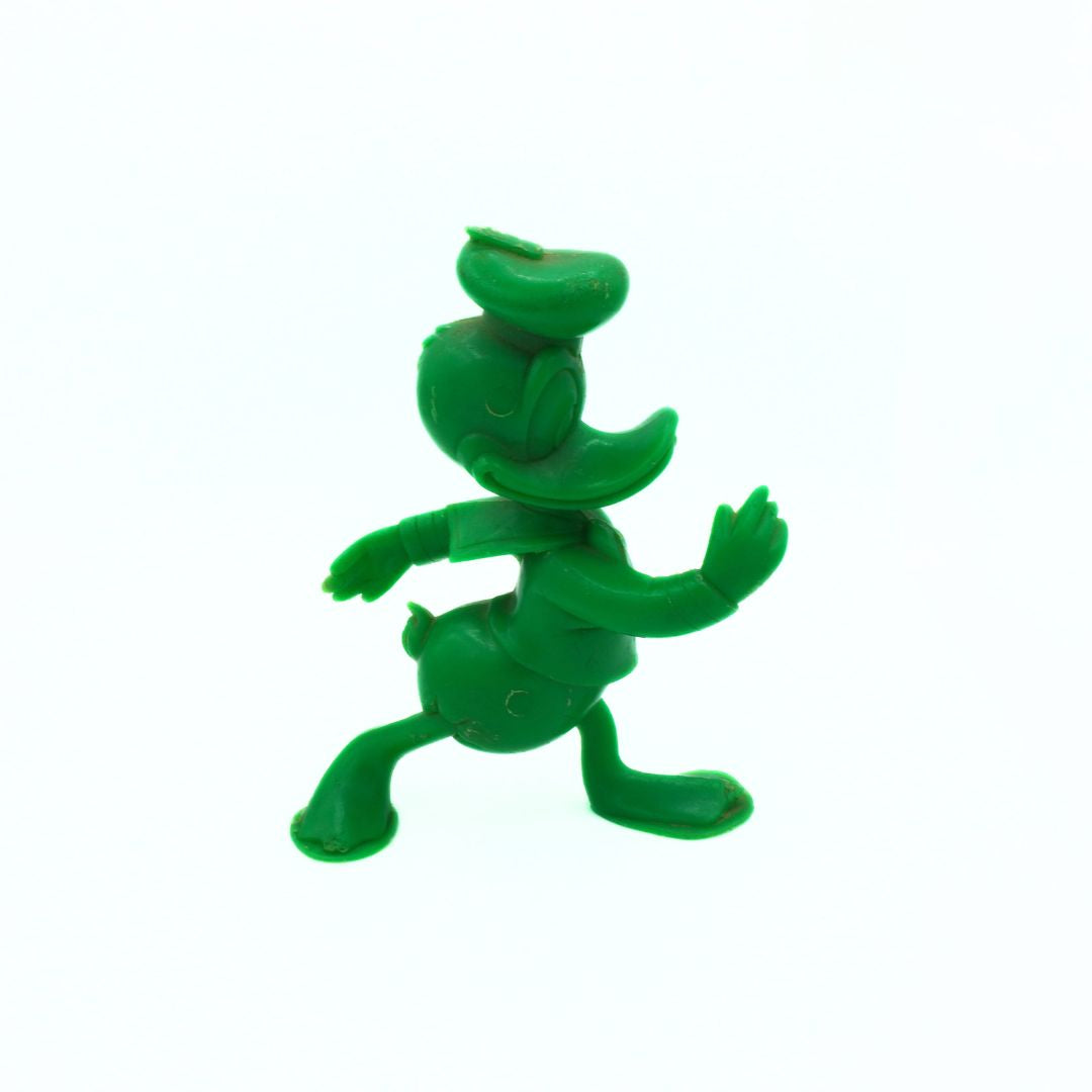 Green plastic figure on a white background