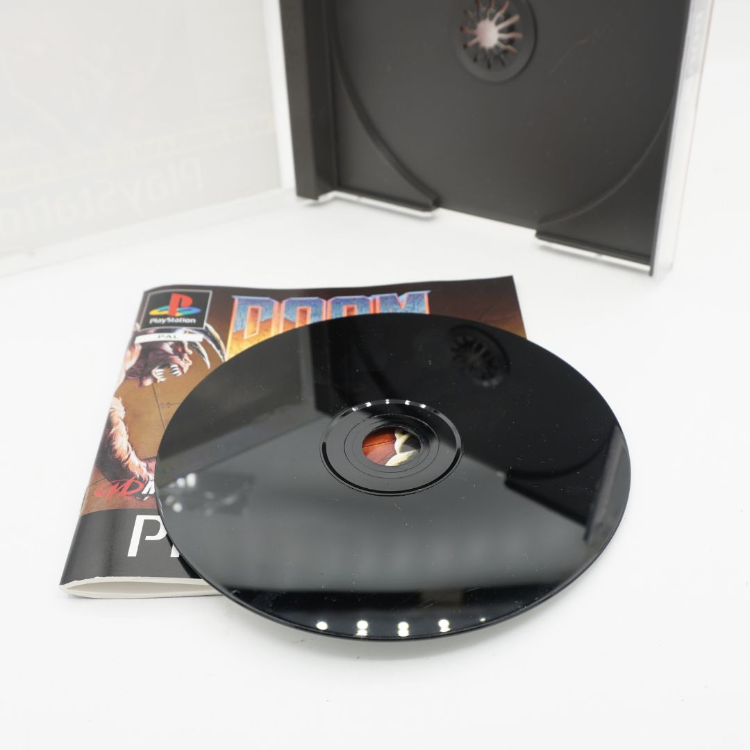 A black disc for the Playstation game of Doom with some scratches