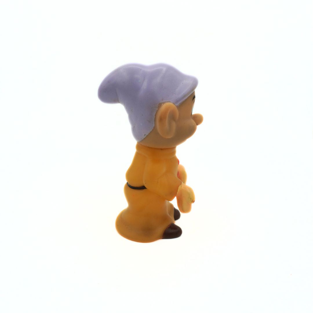 Toy figure of a character with a purple hat on a white background