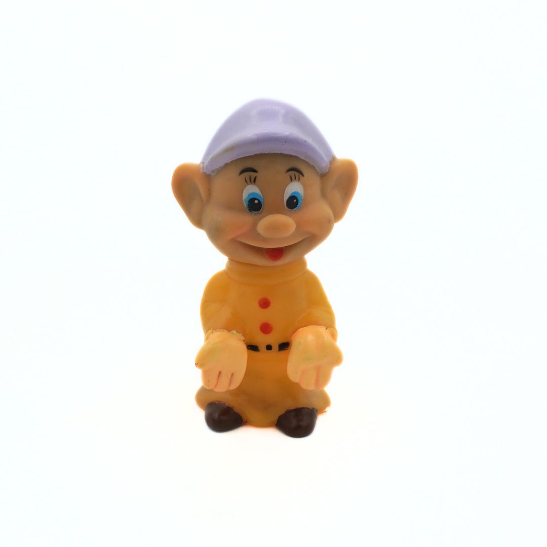 Toy figure of a character with a purple hat on a white background