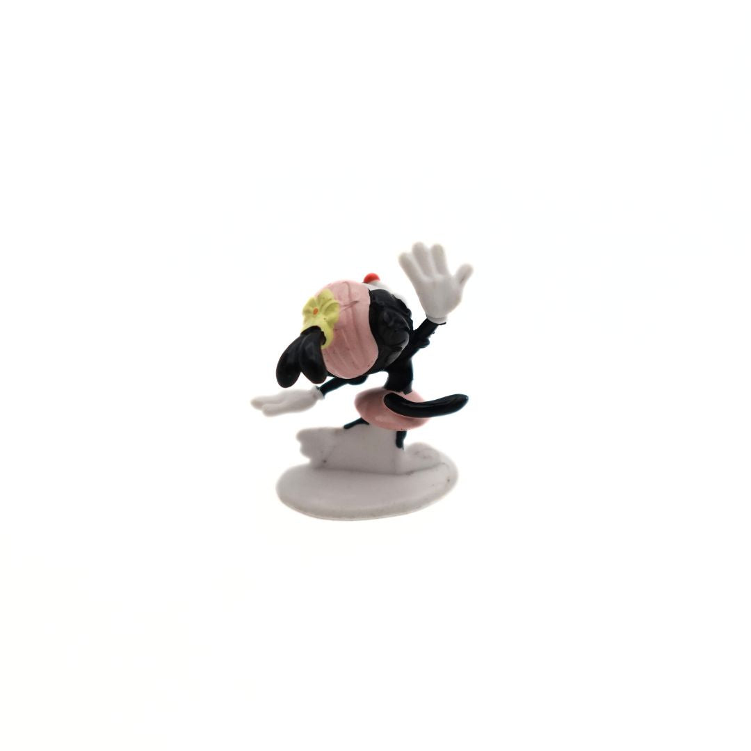 Small Dot Warner figurine, with one arm raised wearing a pink skirt and hat