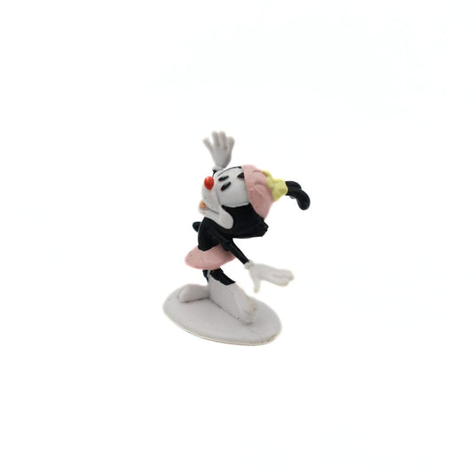 Small Dot Warner figurine, with one arm raised wearing a pink skirt and hat