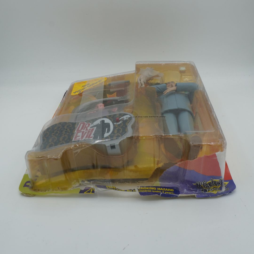 Toy figure in packaging with 'Dr. Evil' branding on a white background