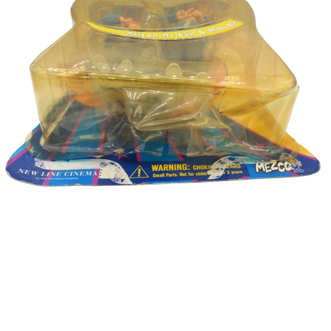 Toy figure in clear packaging with New Line Cinema and Mezco branding on a white background