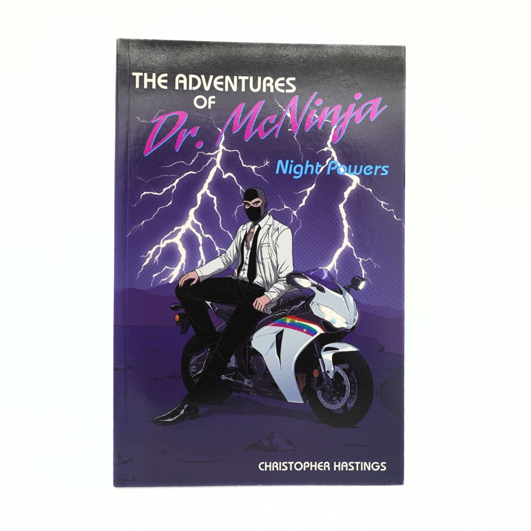 The Adventures of Dr. McNinja: Night Powers book by Christopher Hrstings, featuring a comic-style illustration of a man in a white blazer and black mask sitting on a white and blue motorcycle with lightning bolts in a purple background.