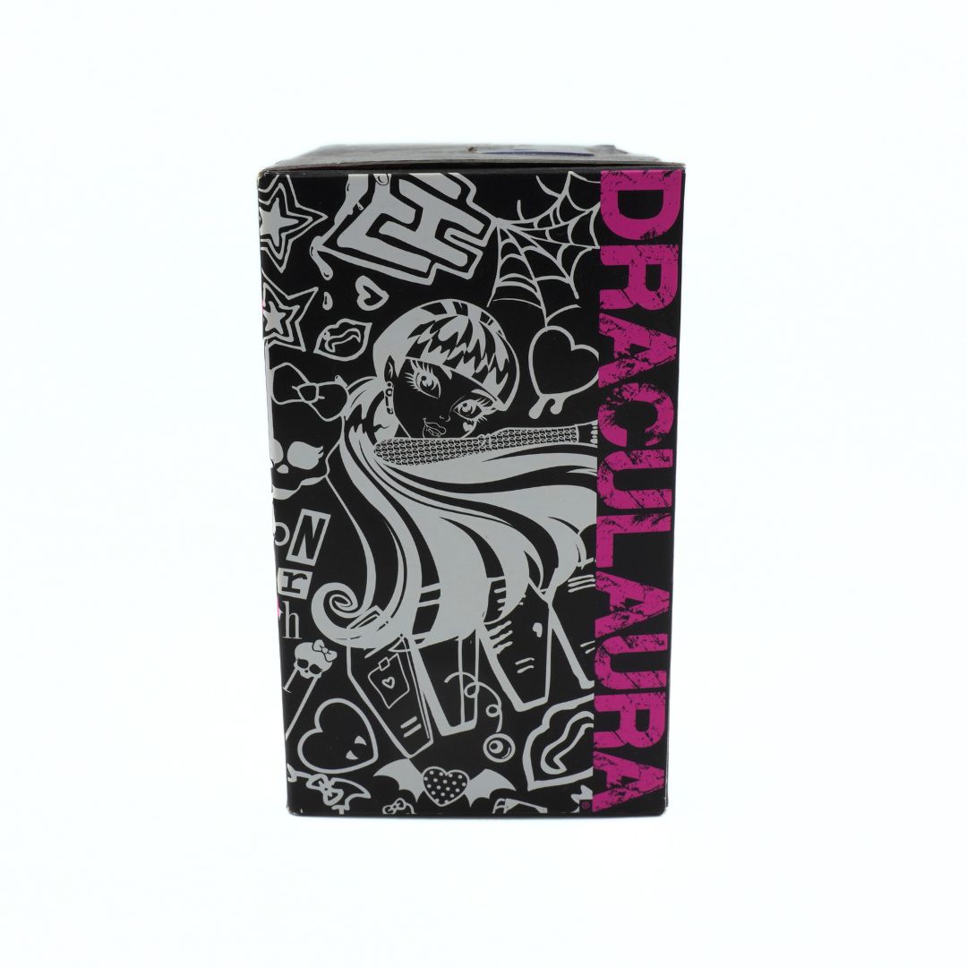 Black box with 'Draculaura' design featuring a character and various symbols on a white background.