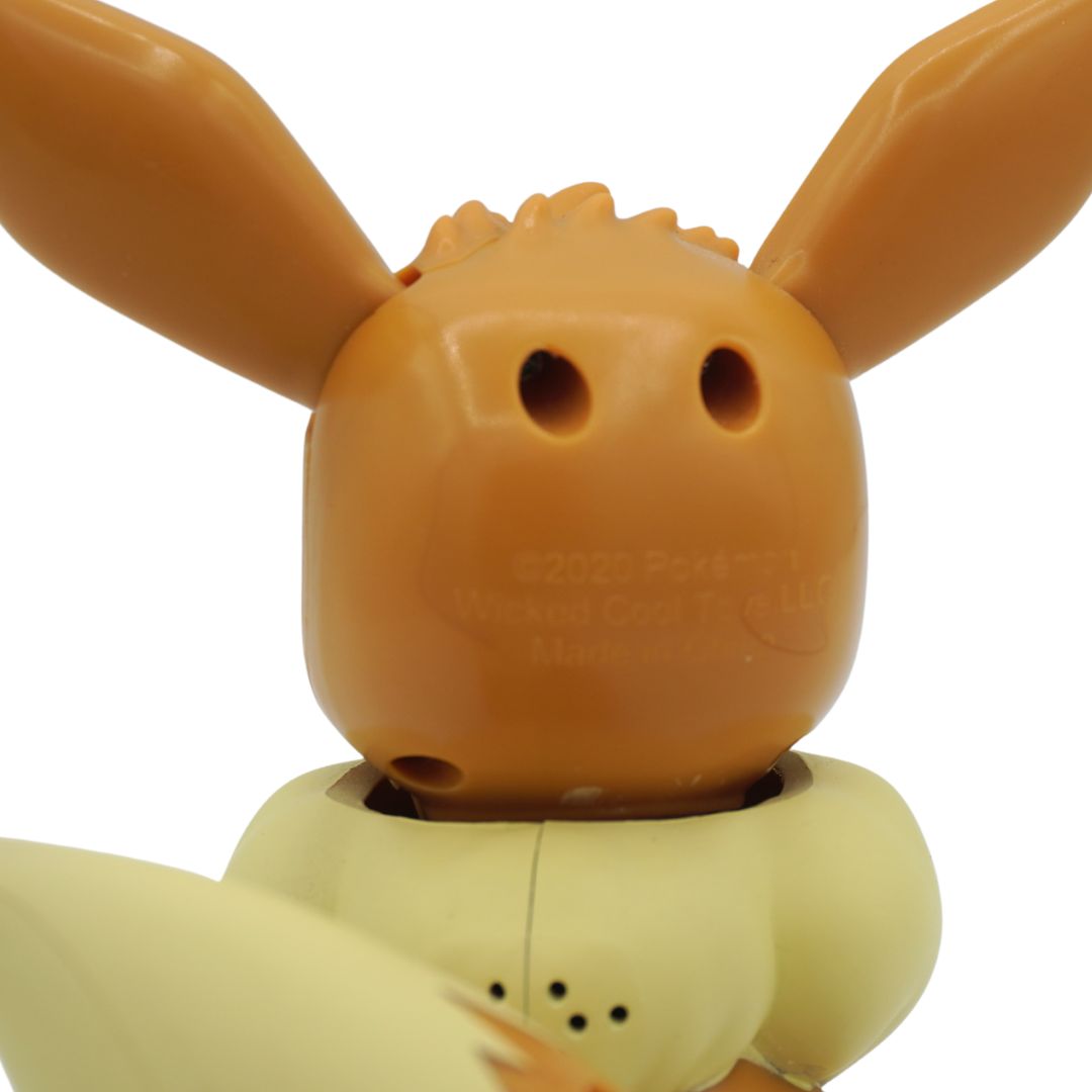 Close up picture of the back of an Eevee electronic toy from the series Pokemon, on a white backdrop showing branding and trademark information