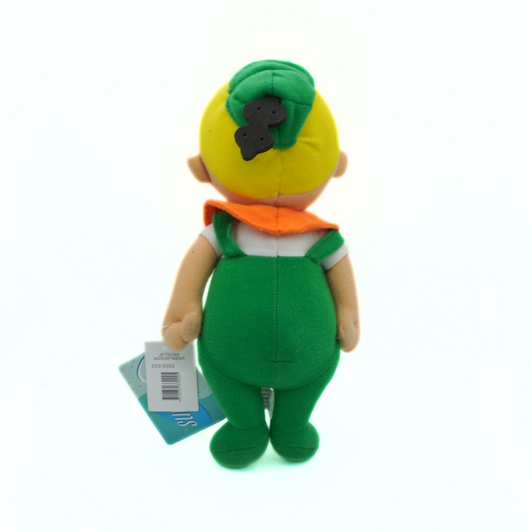 Plush toy with green overalls and yellow head on a white background