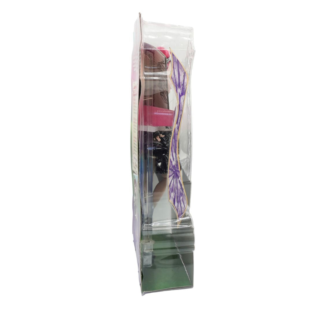 A doll in packaging with a purple and white geometric pattern on the underside, packaged vertically inside a clear plastic display stand.