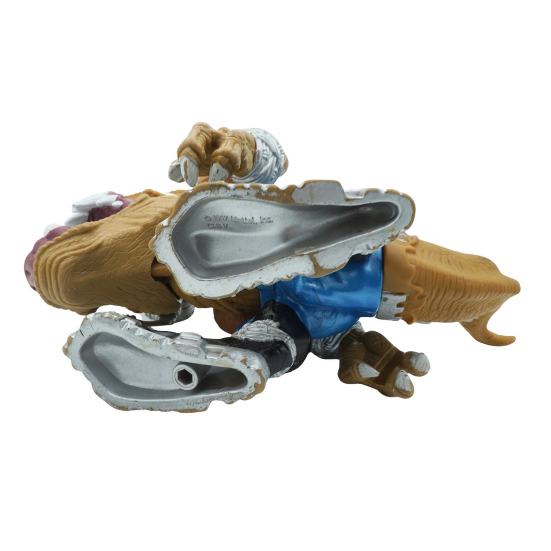 Toy figure of a creature with a metallic mouthpiece on a white background