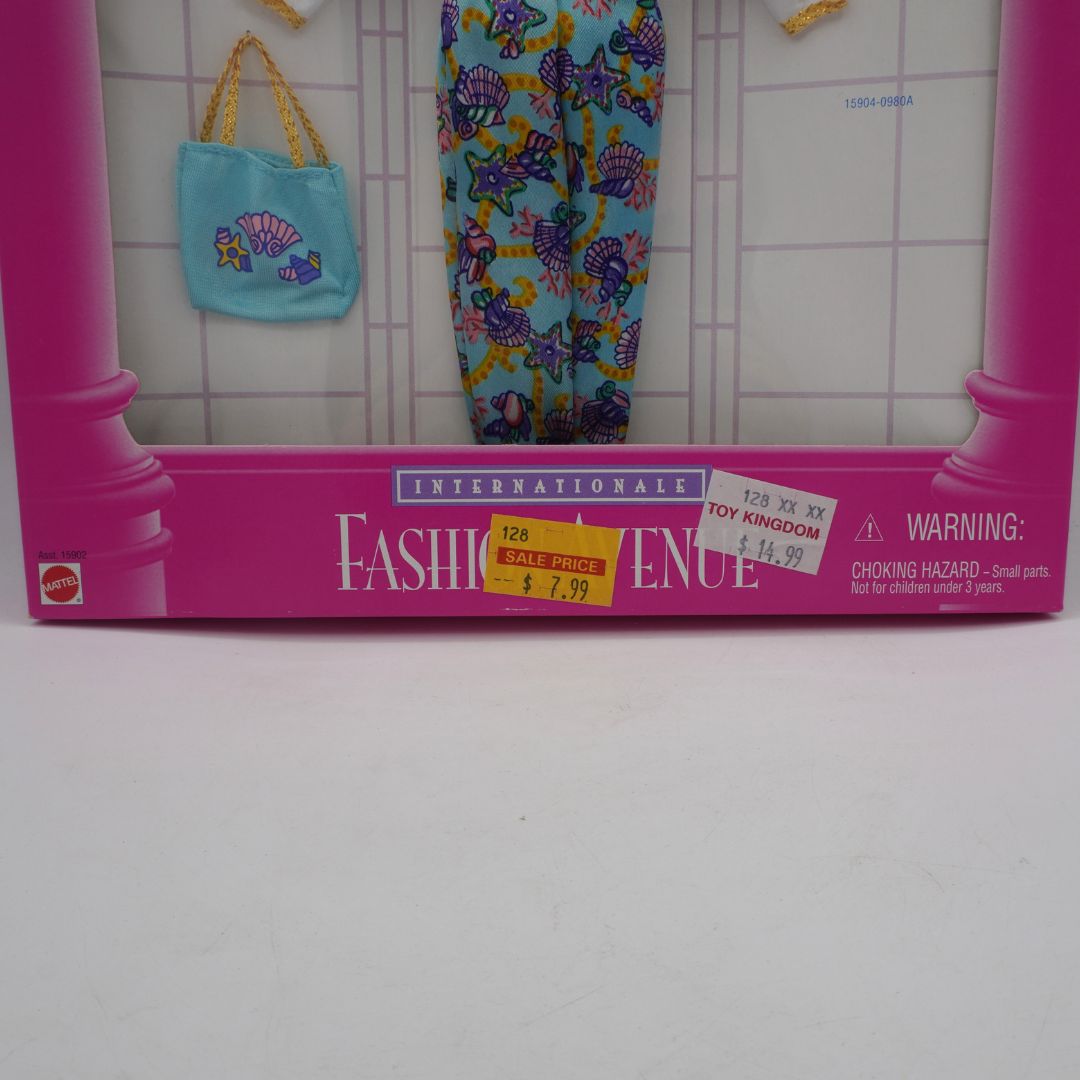 Vintage Fashion Avenue toy box with colorful clothing and accessories on a tiled floor.
