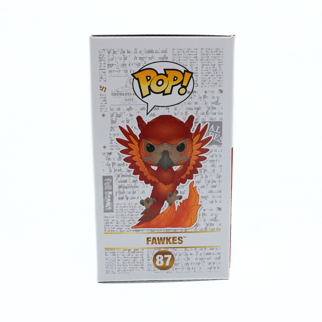 Funko Pop! vinyl figure box featuring the Fawkes character from Harry Potter, with a white background and printed script pattern on the packaging.