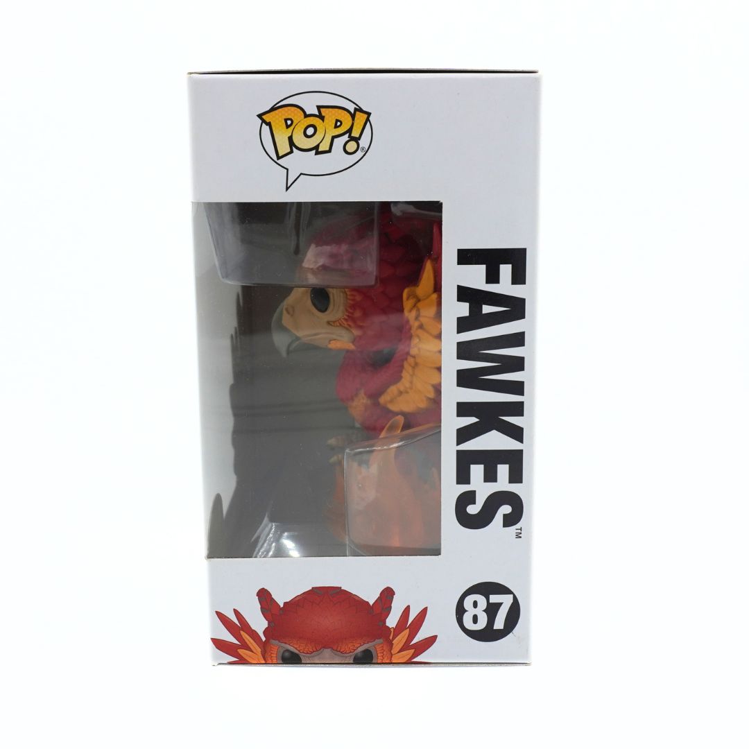 Funko Pop! vinyl figure of Fawkes, the owl from Harry Potter, in its original white window box packaging. The box features the yellow Funko Pop! logo, the name 'FAWKES' in bold black text, and the number 87.