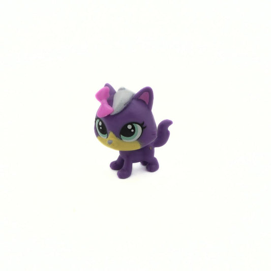 Purple toy cat figure with a pink bow on a white background