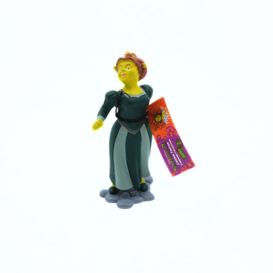 Toy figure of a character from Shrek wearing a green desk with a purple and orange tag