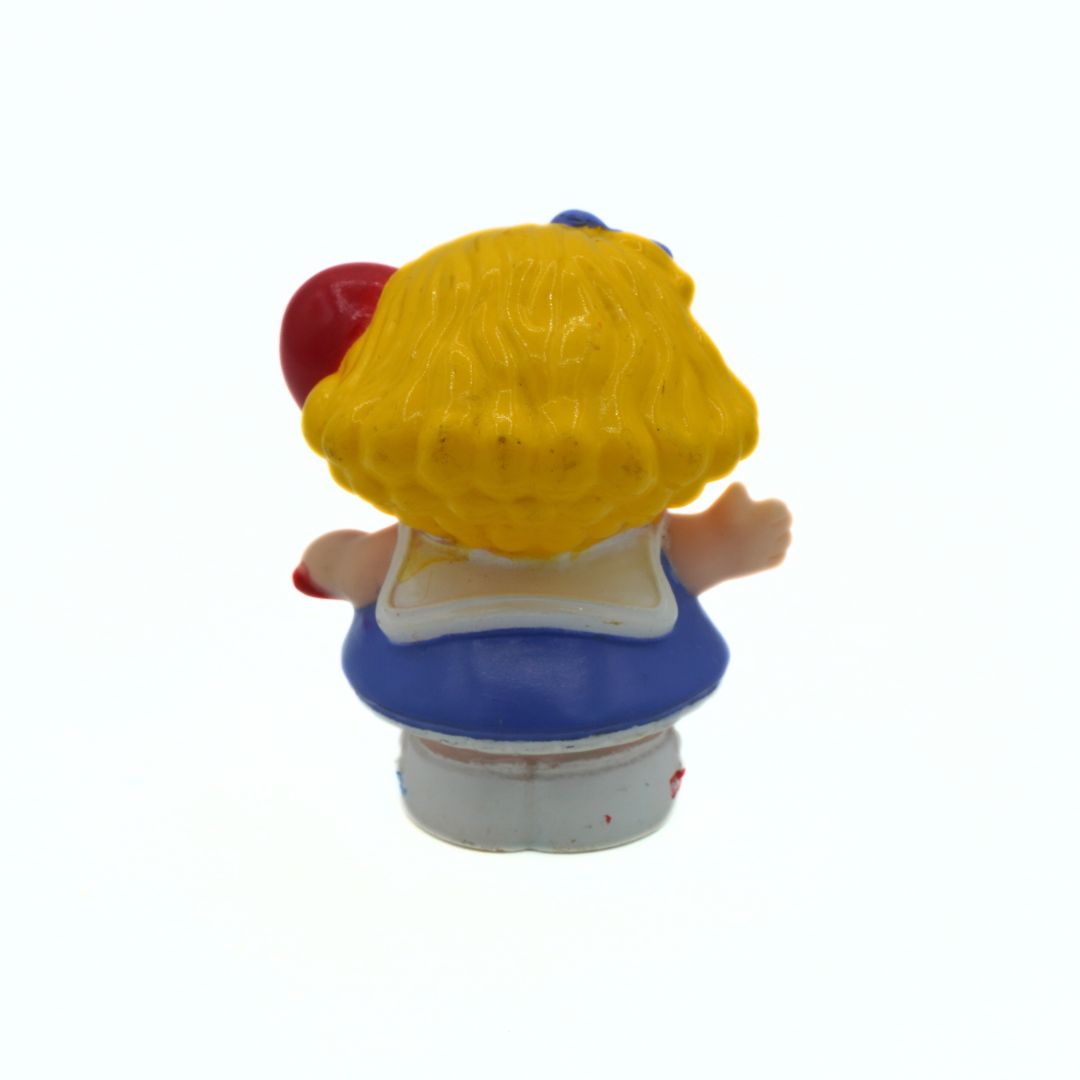 Toy figure with yellow hair and a blue dress on a white background