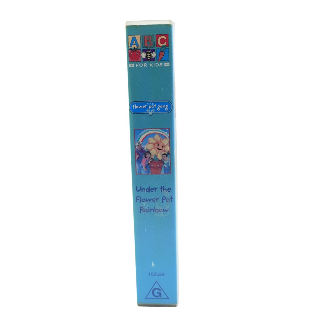 A vintage VHS video case for the children's show 'Under the Flower Pot Rainbow', featuring a light blue spine with colorful cartoon graphics and text, set against a plain white background.