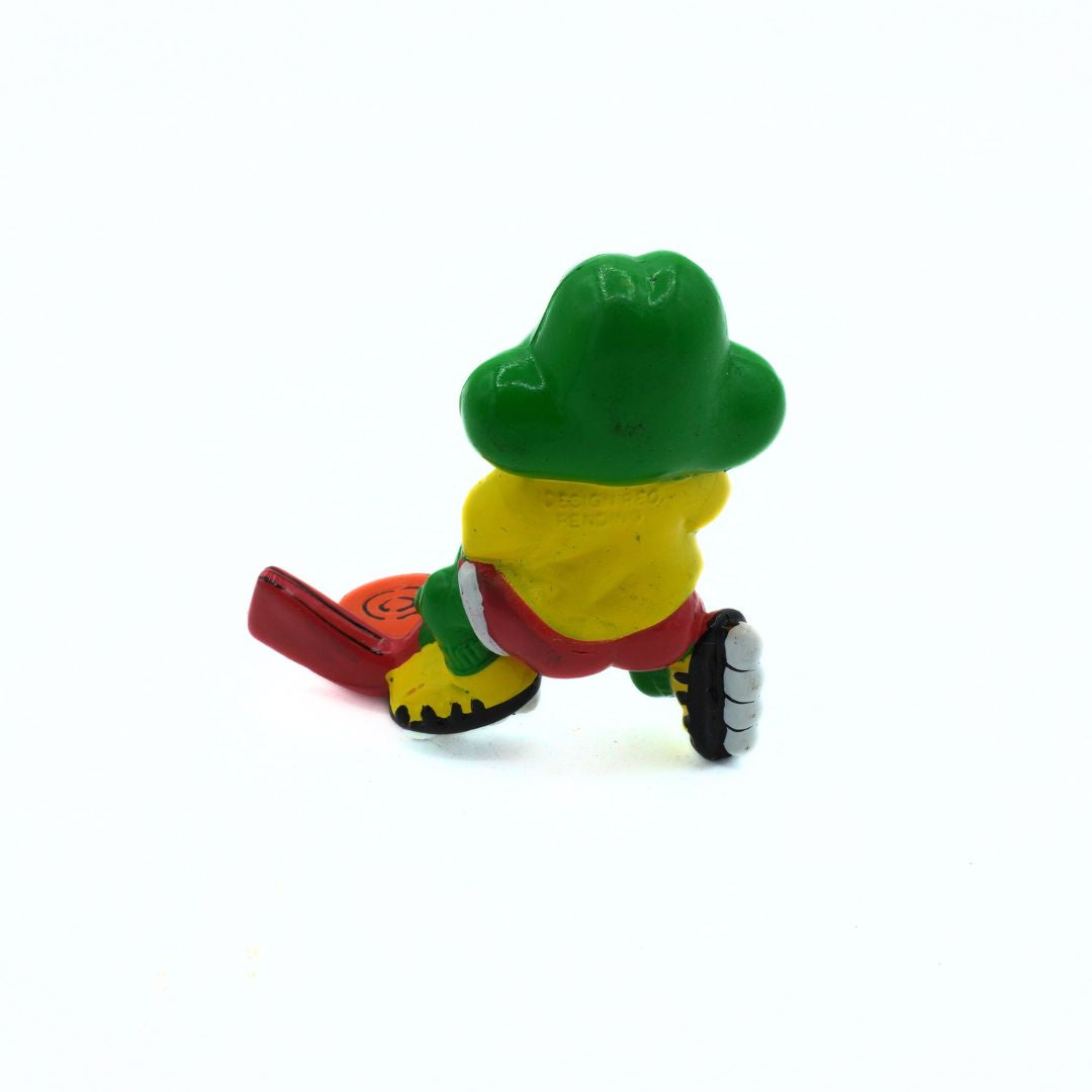Toy figure of a character with green hat and red shoes on a white background