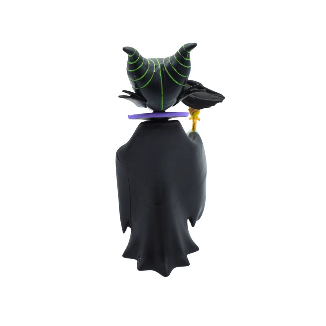 A black vinyl figure of Maleficent from Sleeping Beauty, shown from the back. The figure features her signature black gown, black horns with green web-like patterns, a purple collar, and a small gold staff.