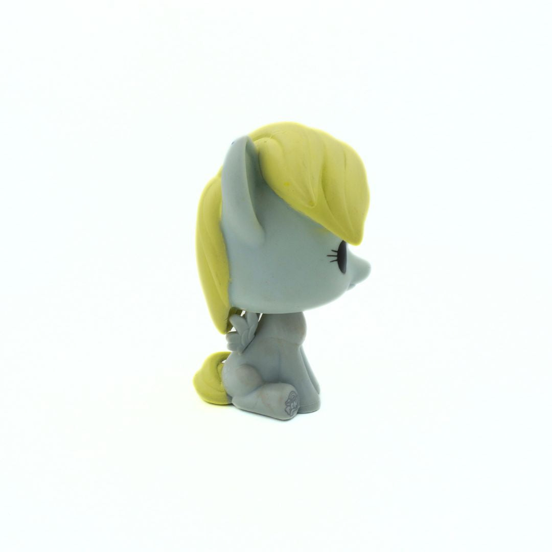 Small figurine with a yellow hat and gray body on a white background