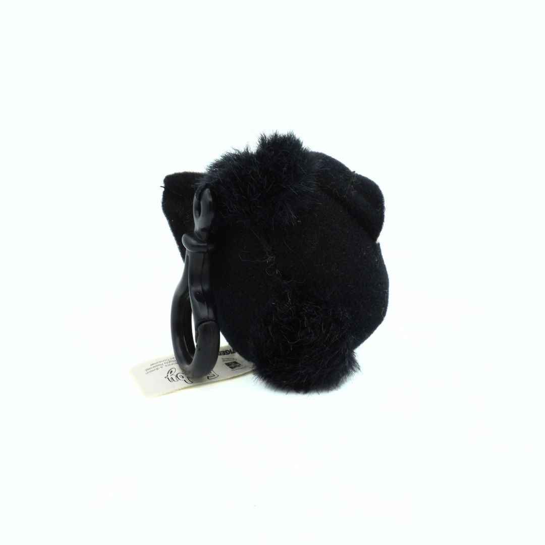 Black fluffy keychain with a tag on a white background