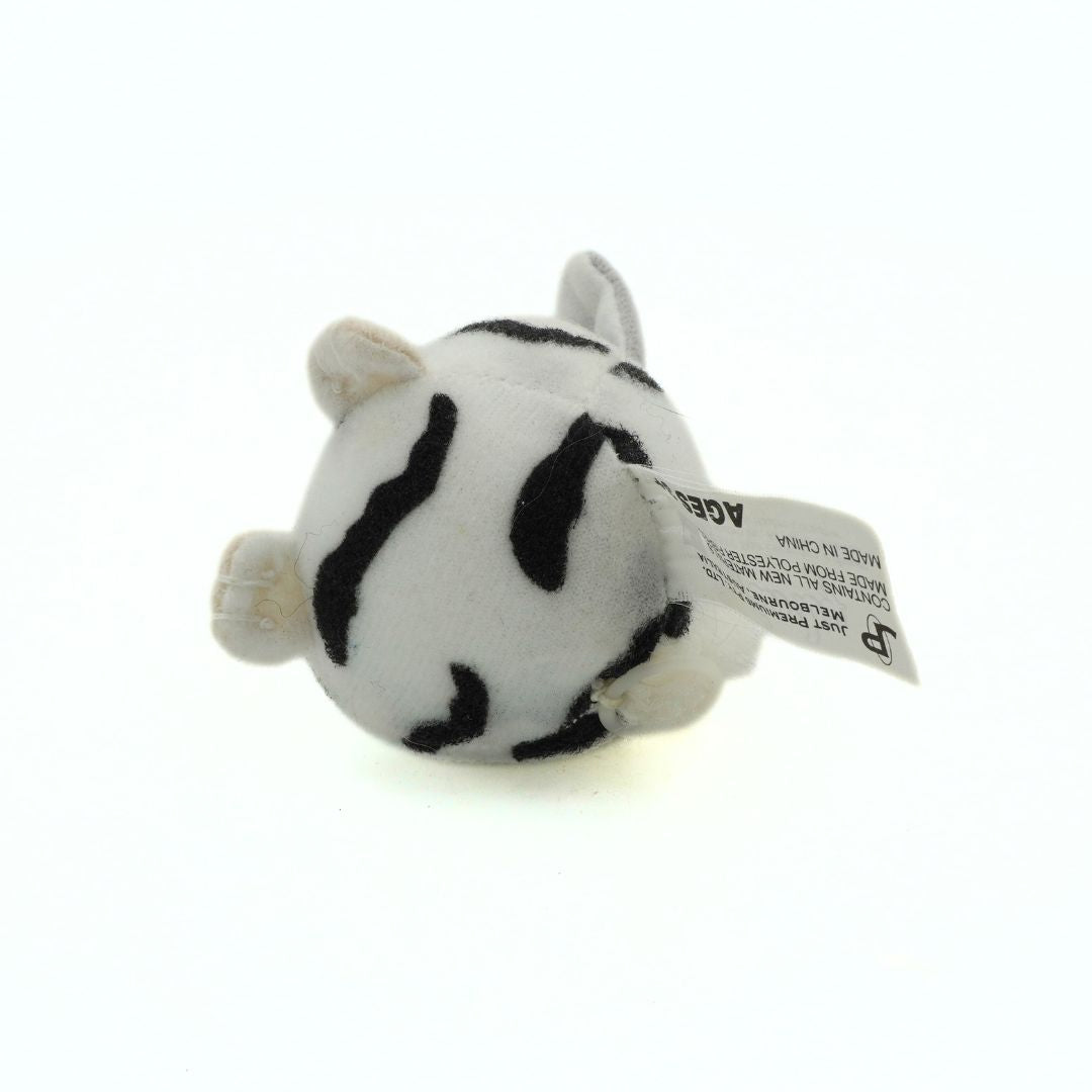 Small plush toy with zebra pattern on a white background