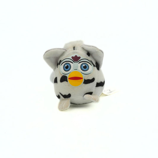Plush toy resembling a character with blue eyes, black spots, and a yellow beak on a white background