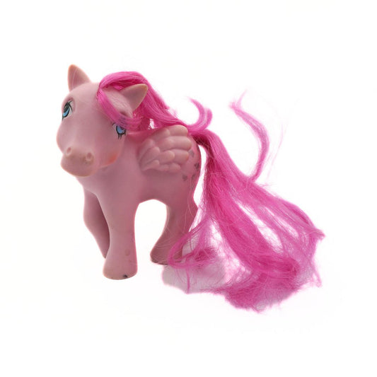 Pink toy horse with long pink hair on a white background