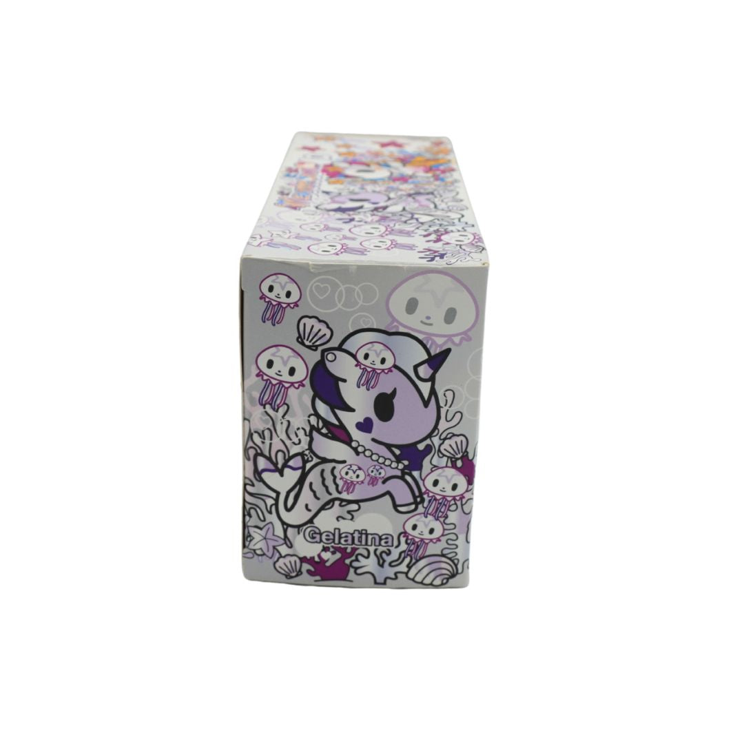 Photo of a colourful Mermicorno Tokidoki box with a set of two purple and white vinyl figurines