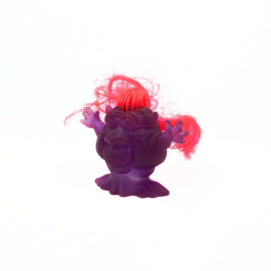 Purple creature with red hair on a white background