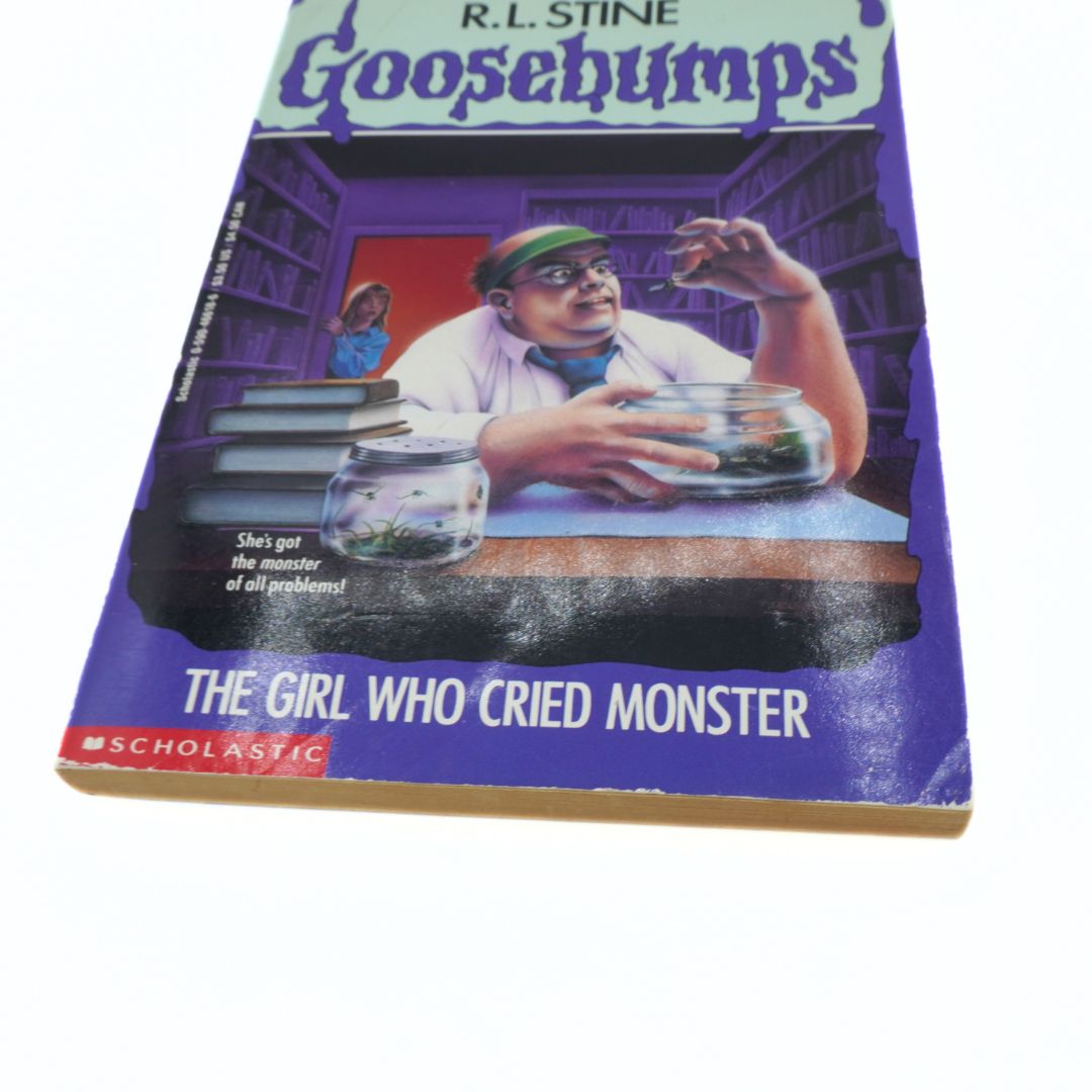 Goosebumps book titled 'The Girl Who Cried Monster' by R.L. Stine on a white background