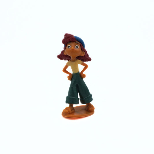 Toy figure of a character with red hair and green pants on a white background