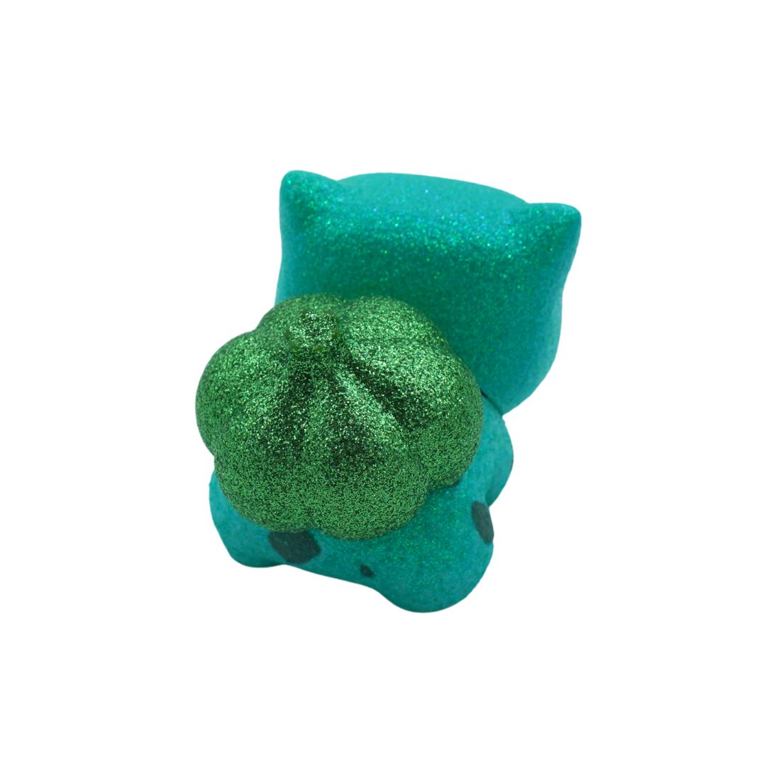 Teal vinyl toy with a green center on a white background