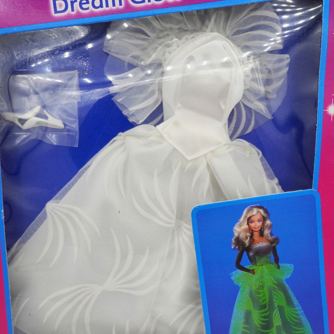 Toy dress in packaging with a doll on a blue card